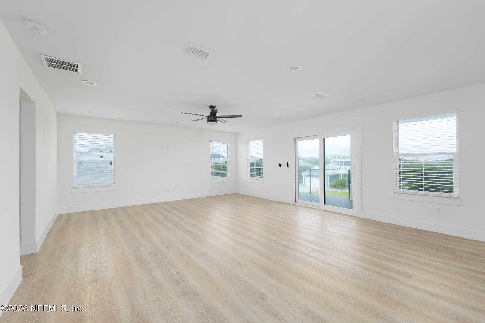 213 Twenty-First Street St. Augustine, FL 32084 - Photo 22 of 50 a view of an empty room with a window and wooden floor