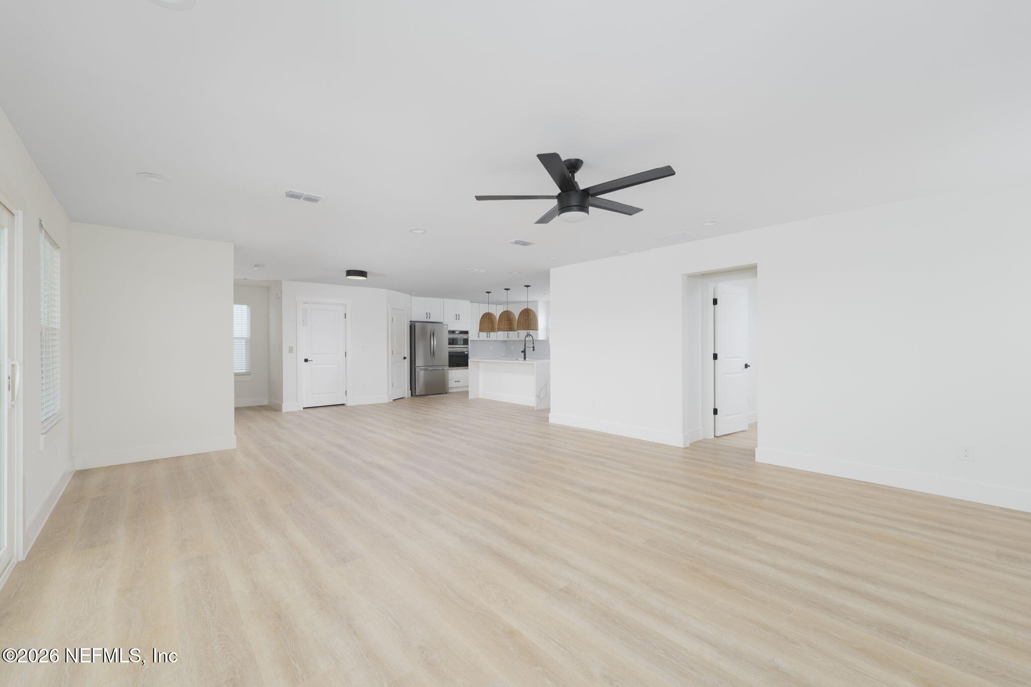 213 Twenty-First Street St. Augustine, FL 32084 - Photo 24 of 50 a view of empty room with wooden floor and ceiling fan