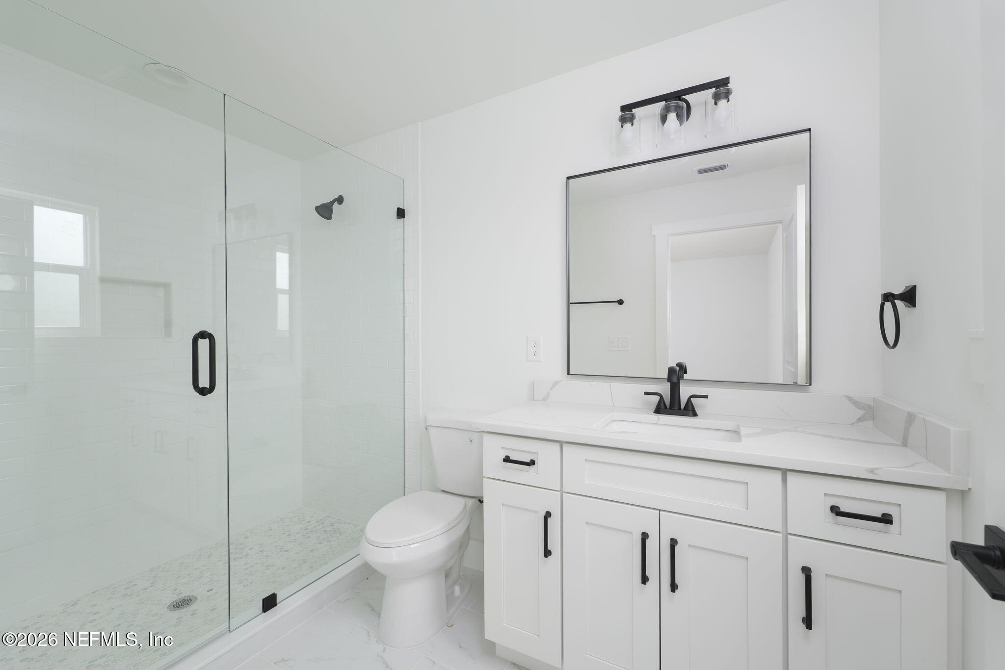 213 Twenty-First Street St. Augustine, FL 32084 - Photo 28 of 50 a bathroom with a granite countertop sink a toilet and a mirror