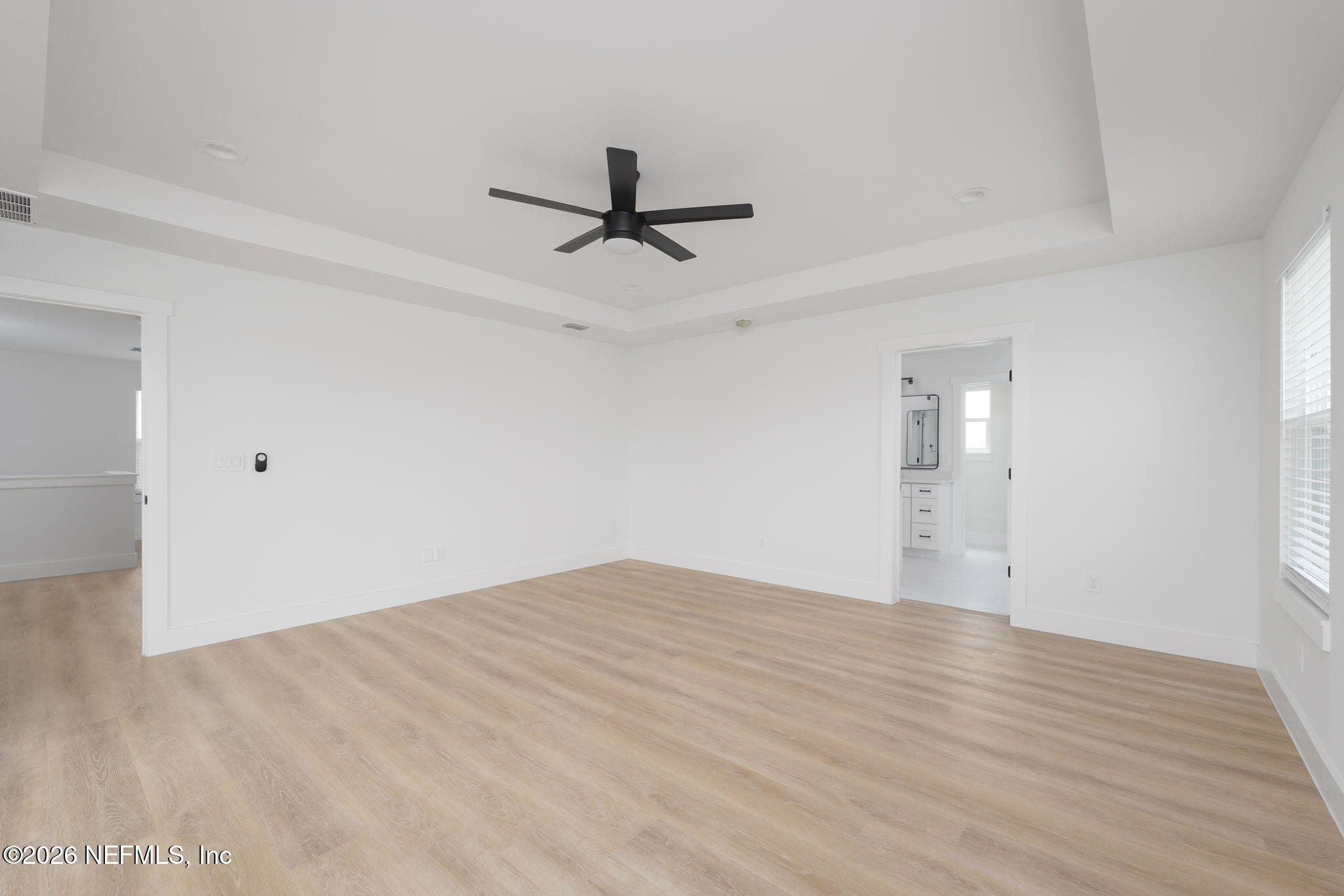 213 Twenty-First Street St. Augustine, FL 32084 - Photo 32 of 50 a view of empty room with wooden floor and ceiling fan