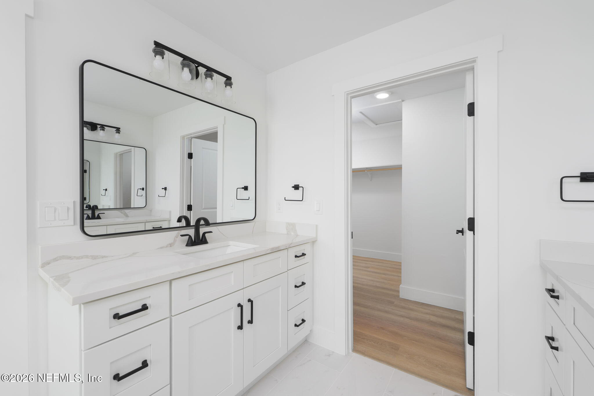 213 Twenty-First Street St. Augustine, FL 32084 - Photo 36 of 50 a bathroom with a double vanity sink and mirror