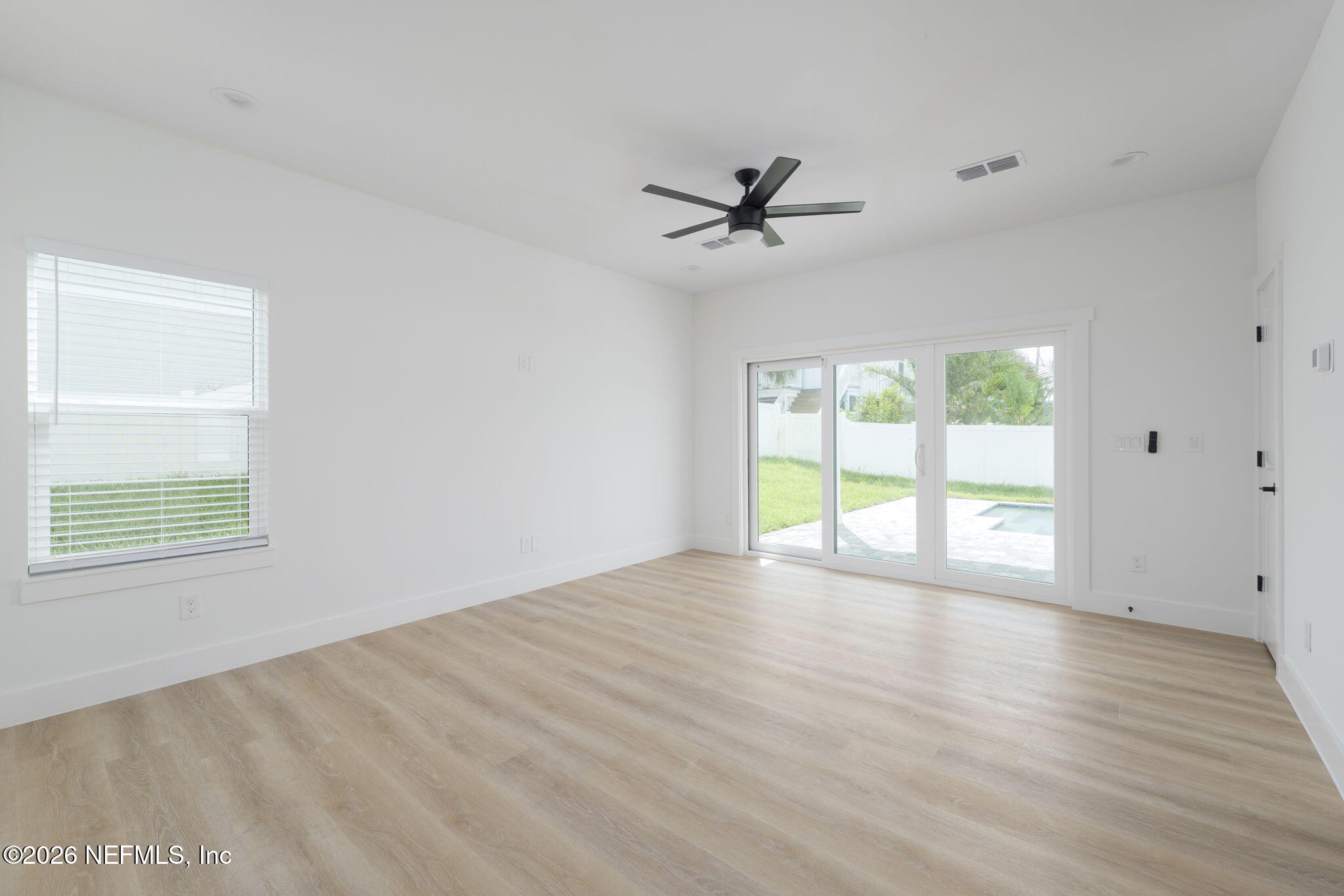213 Twenty-First Street St. Augustine, FL 32084 - Photo 9 of 50 a view of empty room with wooden floor and fan