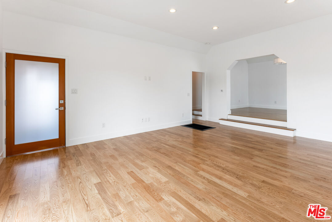 1253 South Rimpau Boulevard Los Angeles, CA 90019 - Photo 49 of 71 a view of an empty room with wooden floor
