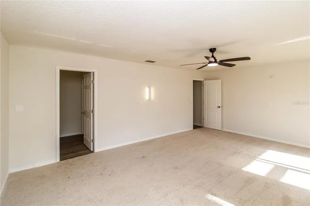 a view of a livingroom with wooden floor and a fireplace