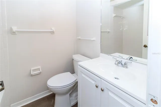 an empty room with closet and a ceiling fan