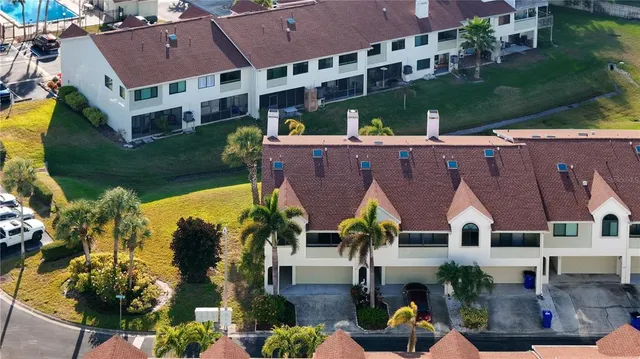an aerial view of a house with a swimming pool outdoor seating and yard
