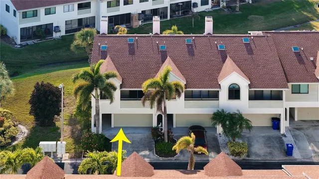 an aerial view of a house with a yard basket ball court and outdoor seating