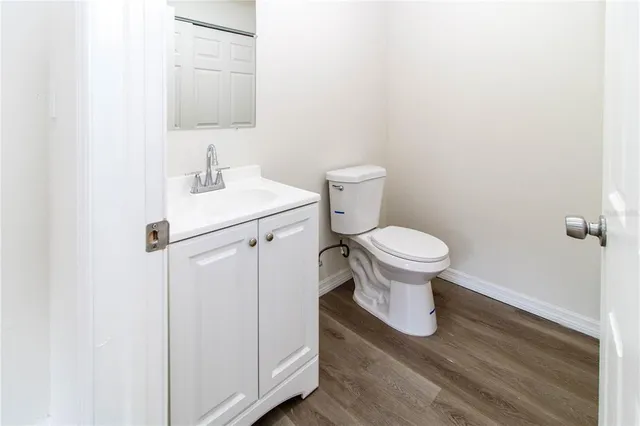 an empty room with a ceiling fan and window