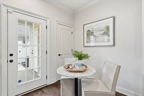 a view of a room that has a table and a chair in it