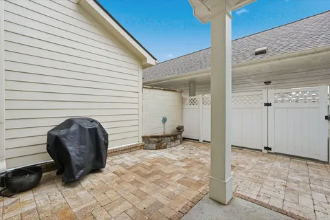 a view of a porch with a table and chairs and couches under an umbrella
