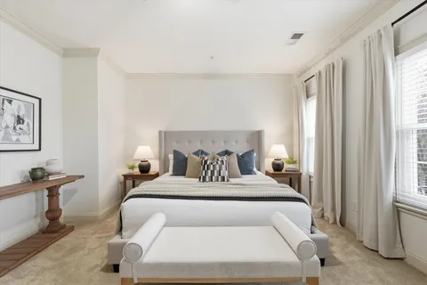 a bedroom with a large bed and a window