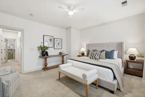 a spacious bedroom with a bed and a table