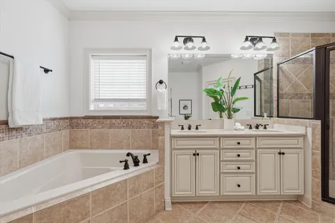 a bathroom with a bathtub sink and mirror