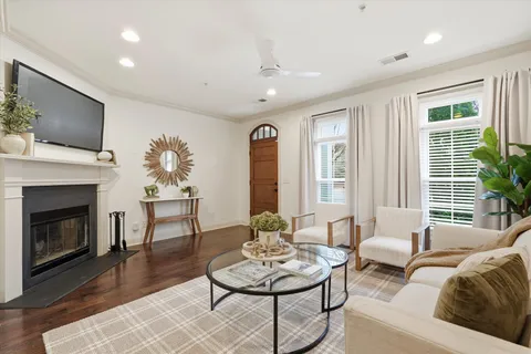 a living room with furniture a fireplace and a flat screen tv