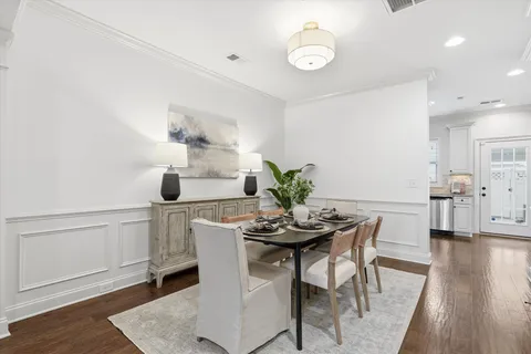 a view of a dining room with furniture and wooden floor