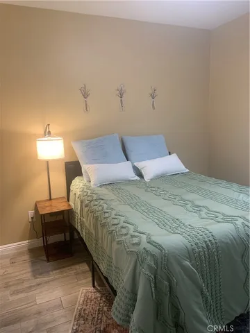 a bedroom with a bed and a lamp