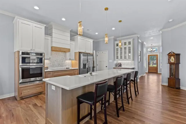 a large kitchen with a table and chairs