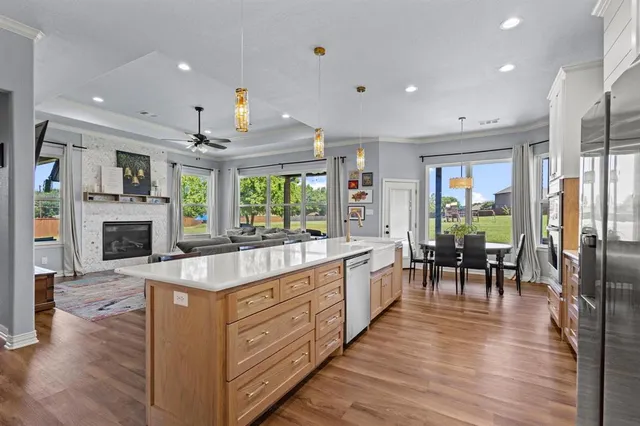 a large kitchen with kitchen island a large island cabinets and wooden floor