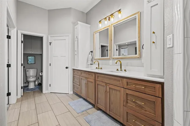 a spacious bathroom with a shower sink and mirror