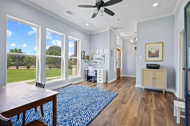 a living room with fireplace furniture and a large window