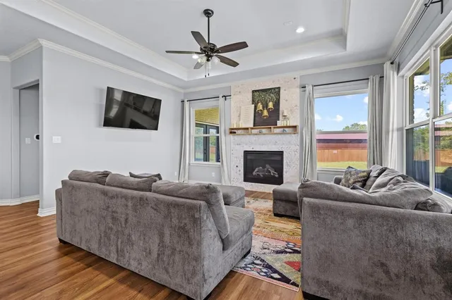 a living room with furniture a flat screen tv and a fireplace