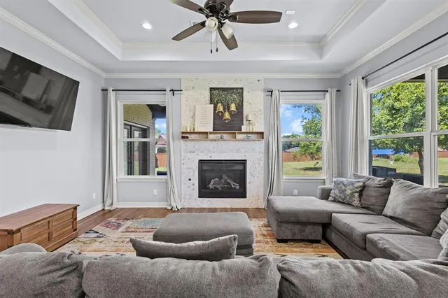 a living room with furniture a flat screen tv and a fireplace