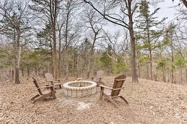 a view of a backyard with table and chairs and a fire pit