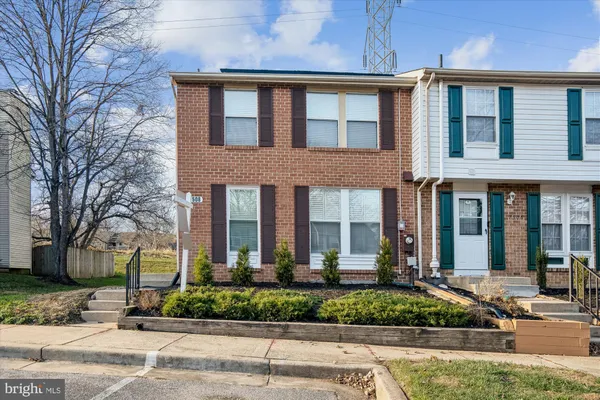front view of a brick house with a yard