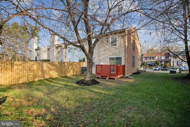 a view of a yard with wooden fence