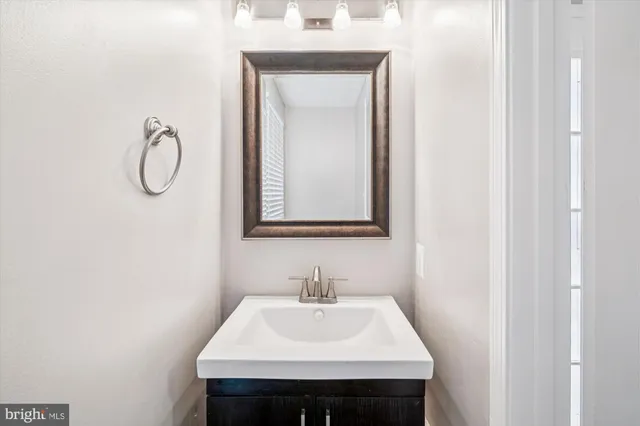 a bathroom with a sink vanity and a mirror