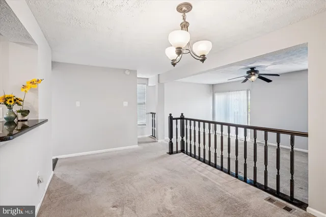 a view of a chandelier fan and a window