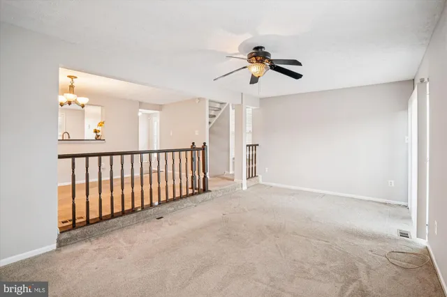 a view of a livingroom with a ceiling fan and window
