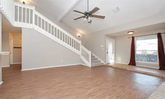 a view of an entryway with wooden floor