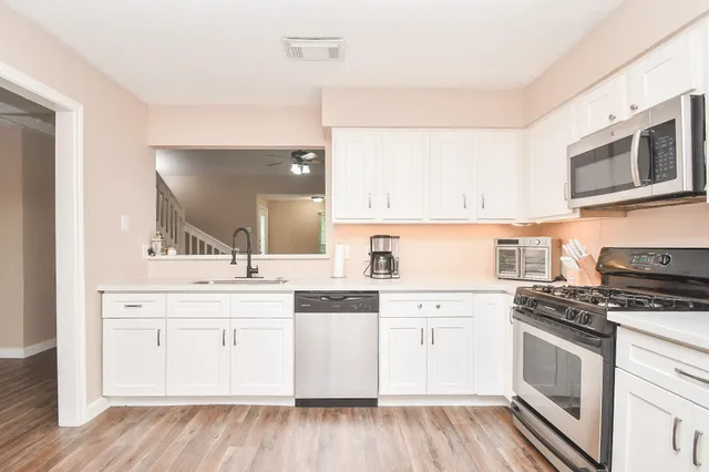 a kitchen with stainless steel appliances granite countertop a stove and a sink