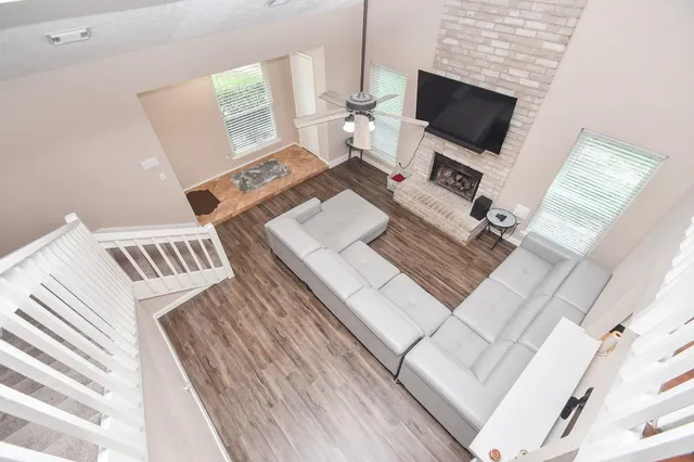 a living room with a bed and a flat screen tv