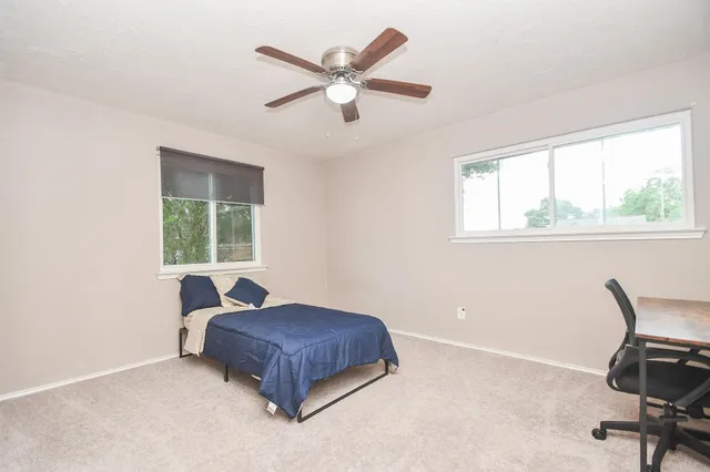 a bedroom with a bed and a window