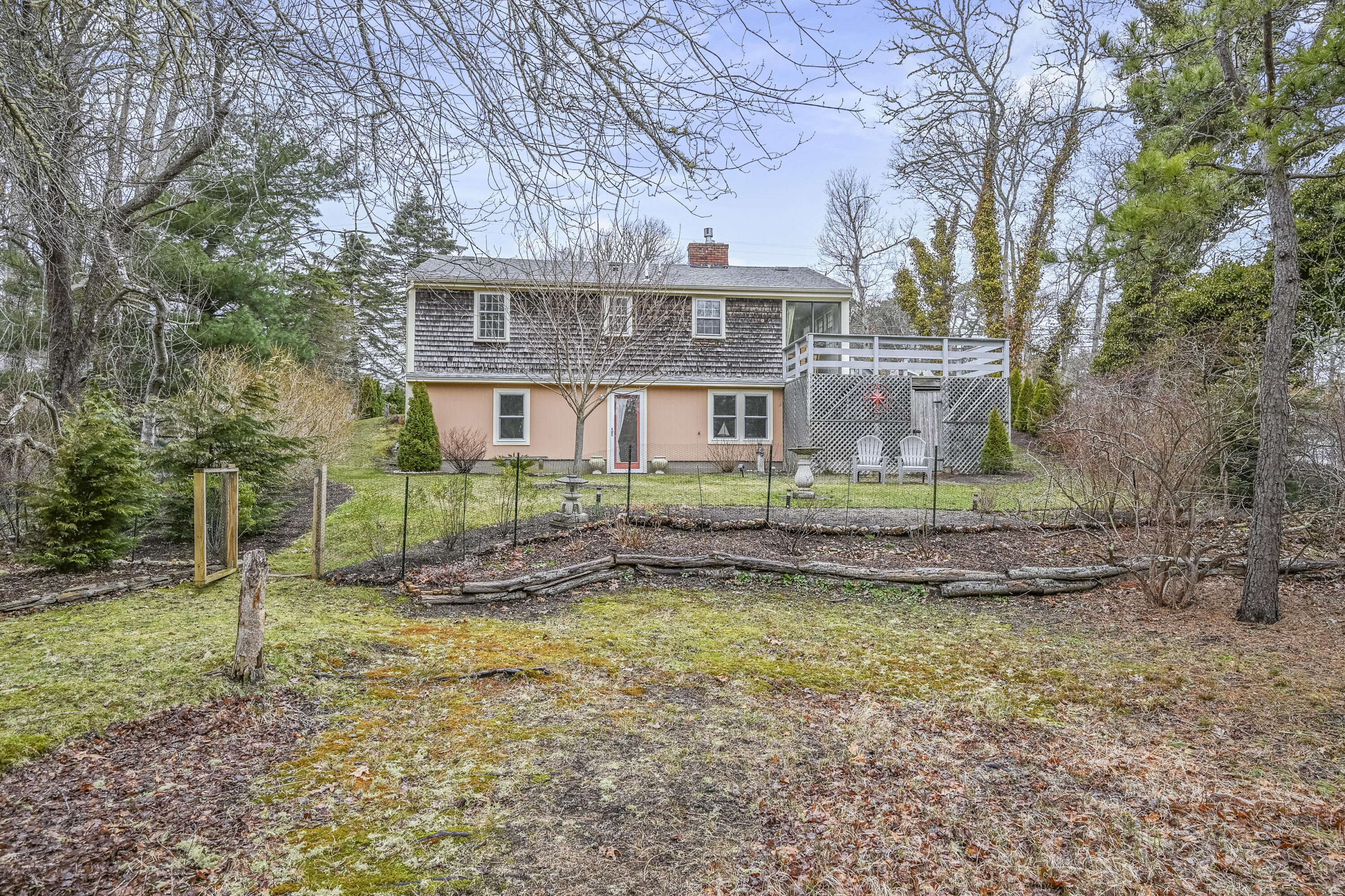 1157 Orleans-Harwich Road Harwich, MA 02645 - Photo 2 of 41 a front view of a house with a yard table and chairs