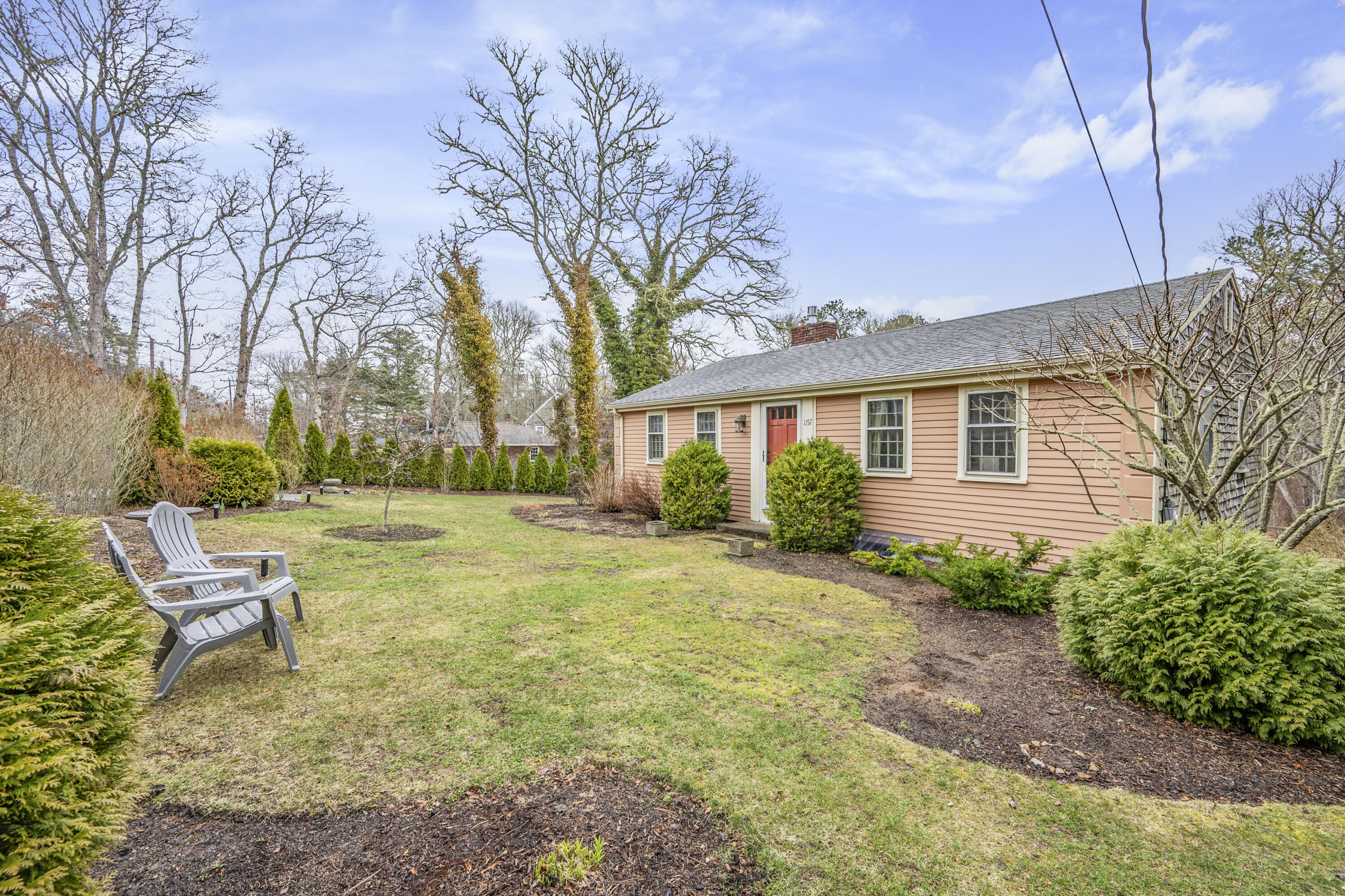 1157 Orleans-Harwich Road Harwich, MA 02645 - Photo 26 of 41 a backyard of a house with table and chairs