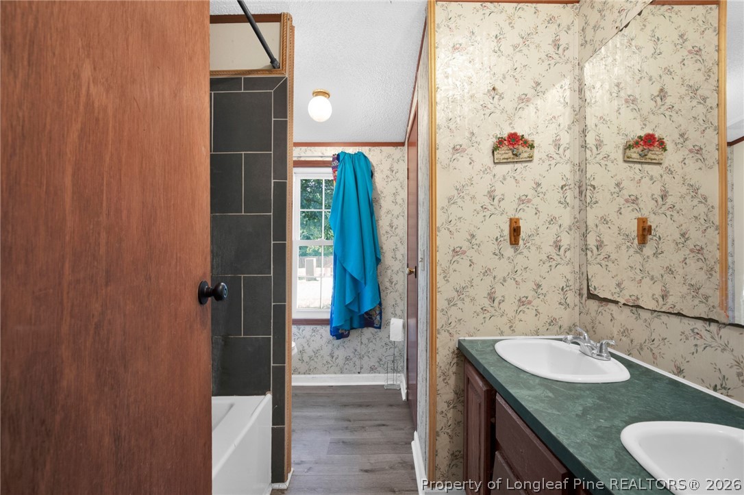 4705 Hickory Ridge Road Parkton, NC 28371 - Photo 30 of 37 a bathroom with a granite countertop sink a toilet and shower