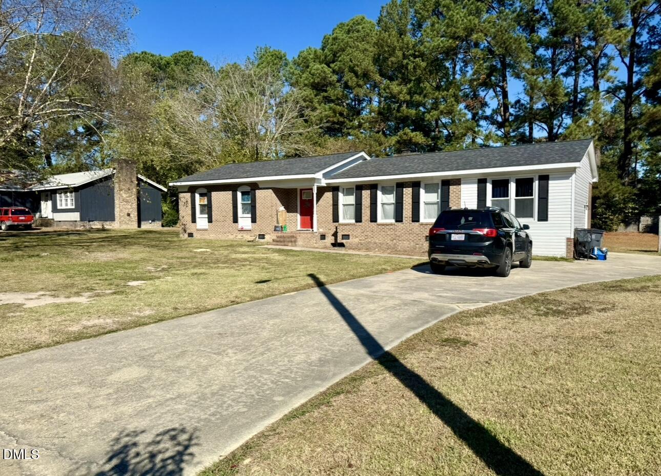 2720 Buff Road Rocky Mount, NC 27803 - Photo 1 of 8 a front view of a house with a yard with seating space