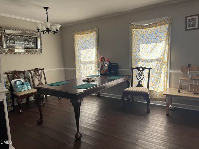 a living room with furniture a window and a chandelier