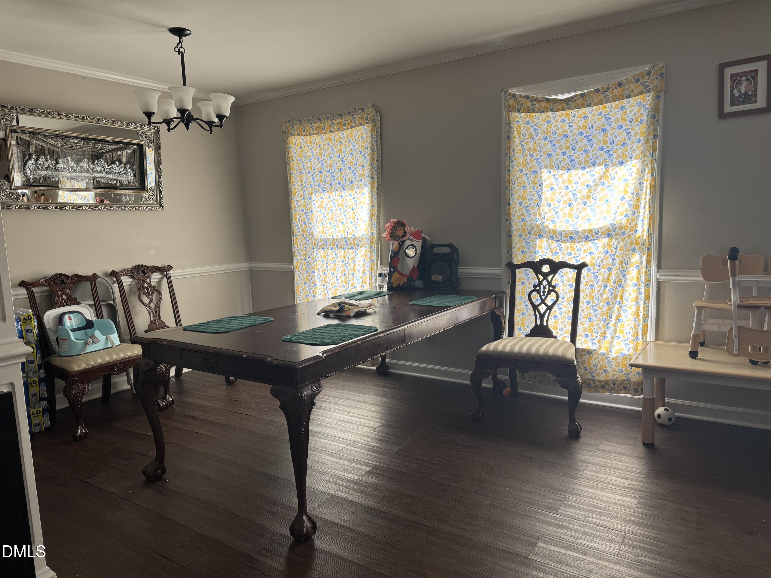 2720 Buff Road Rocky Mount, NC 27803 - Photo 6 of 8 a living room with furniture a window and a chandelier
