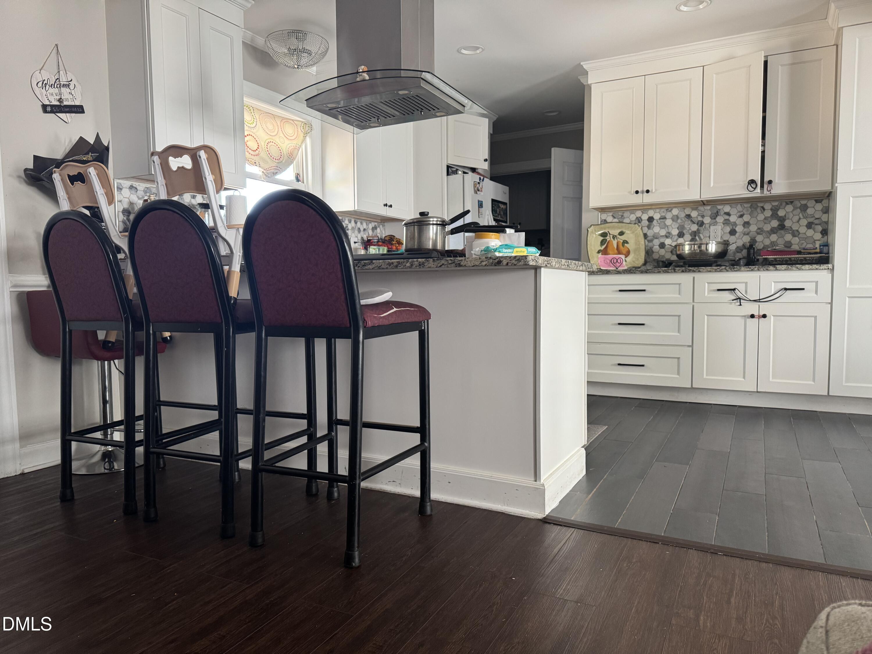 2720 Buff Road Rocky Mount, NC 27803 - Photo 7 of 8 a kitchen with cabinets wooden floor and dining table chairs