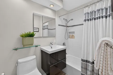 a bathroom with a sink toilet and shower