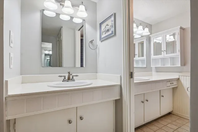 a bathroom with a sink vanity and a mirror
