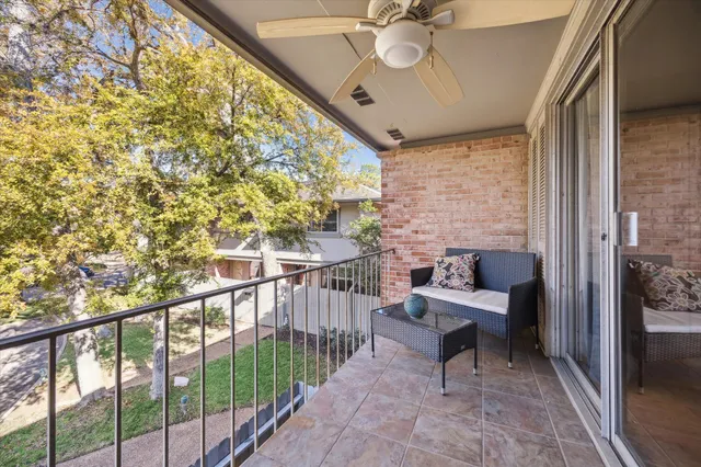 a view of a porch with furniture and a gate