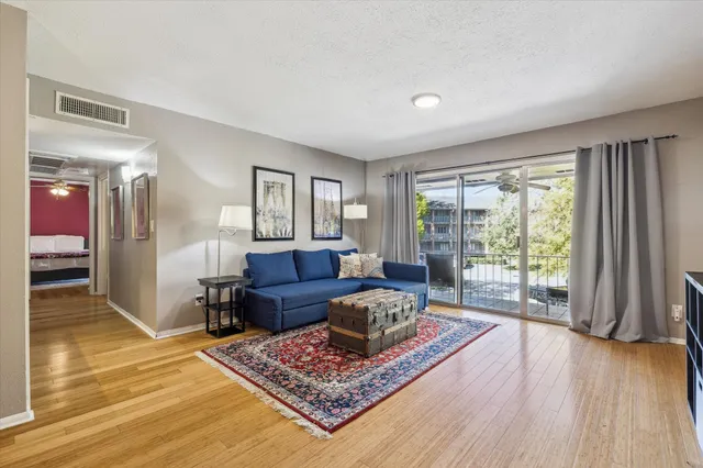 a living room with furniture and a wooden floor