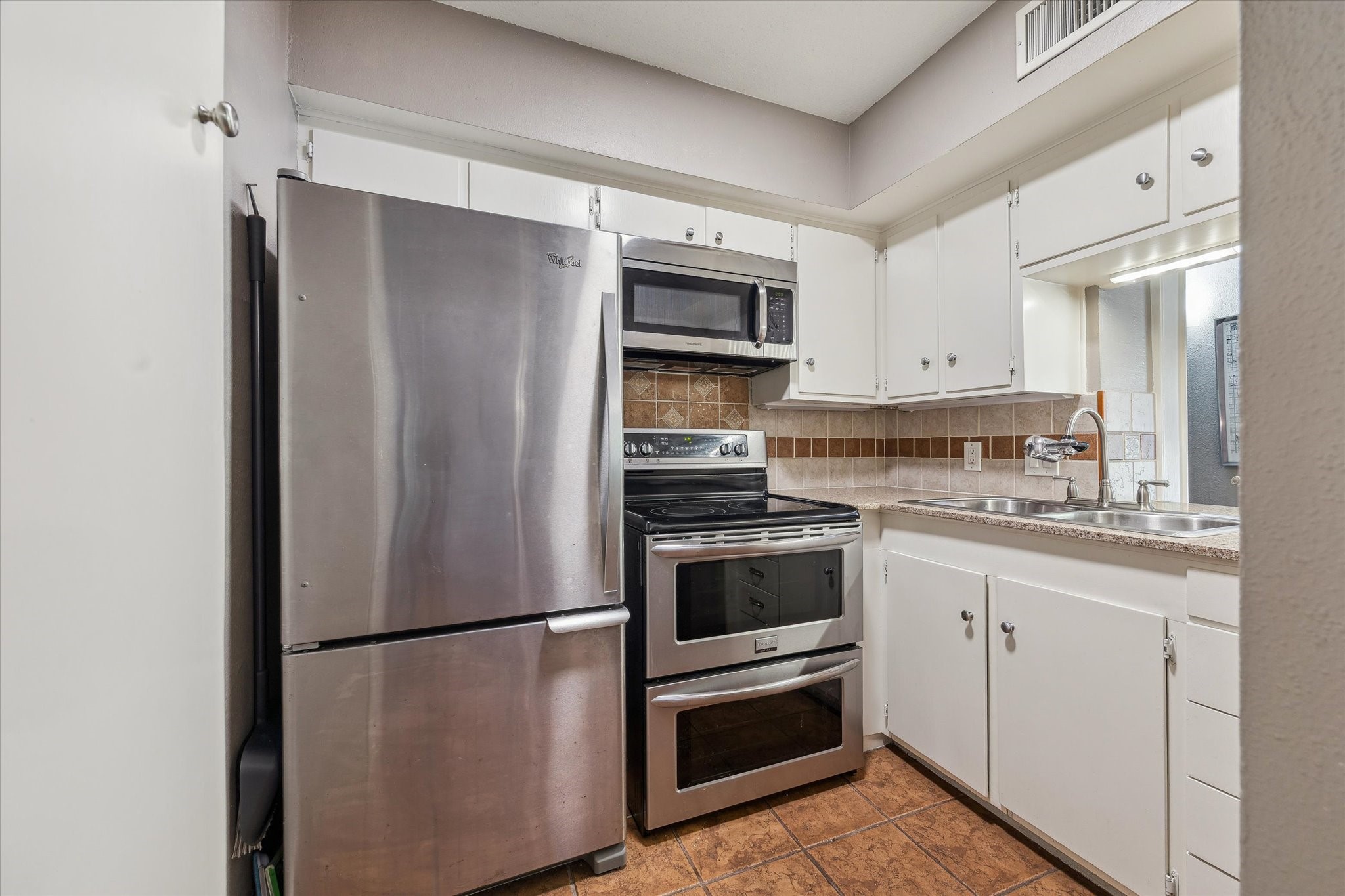 6465 Bayou Glen Road Houston, TX 77057 - Photo 5 of 15 a white refrigerator freezer sitting inside of a kitchen