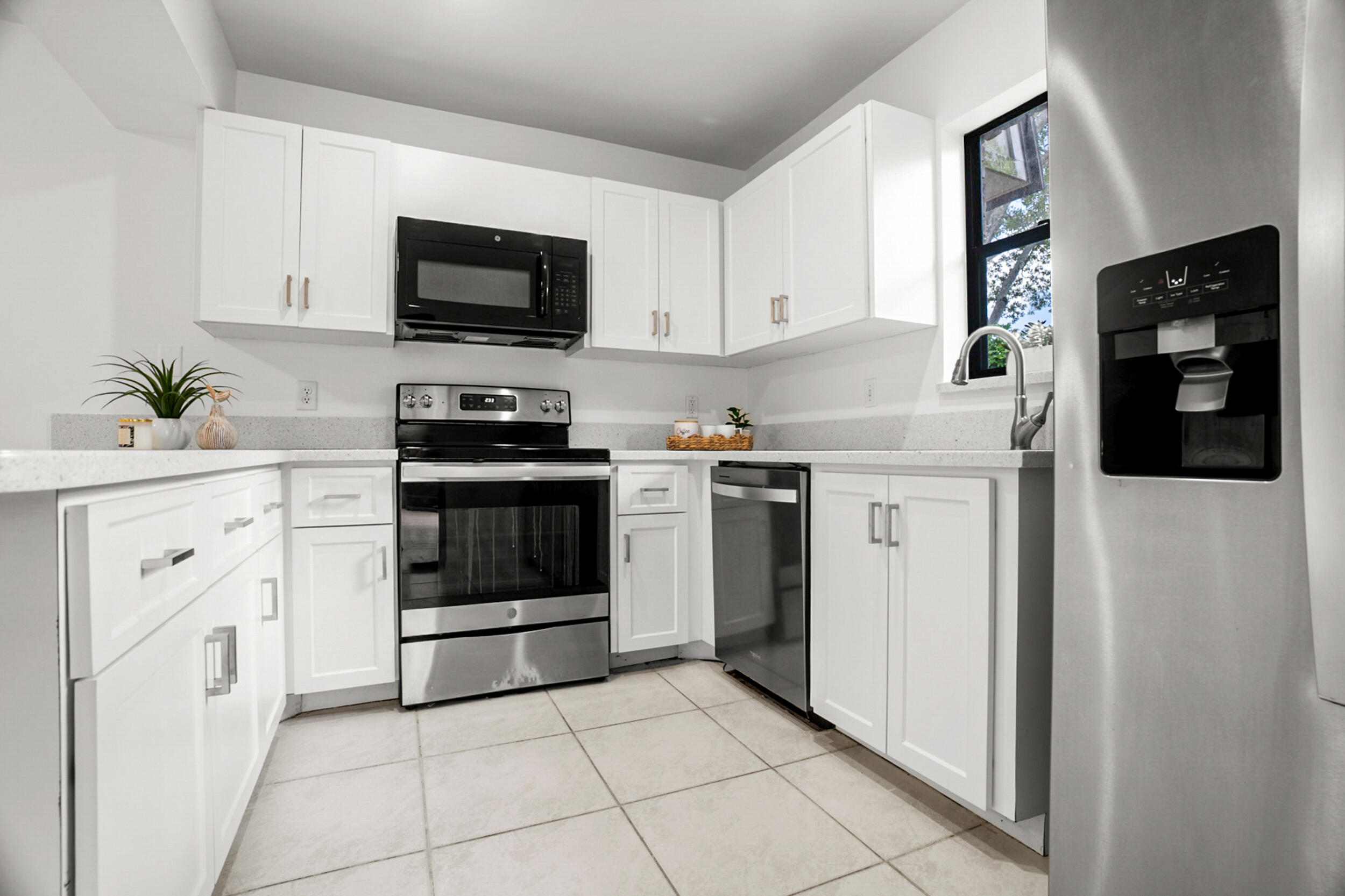 a kitchen with white cabinets and appliances