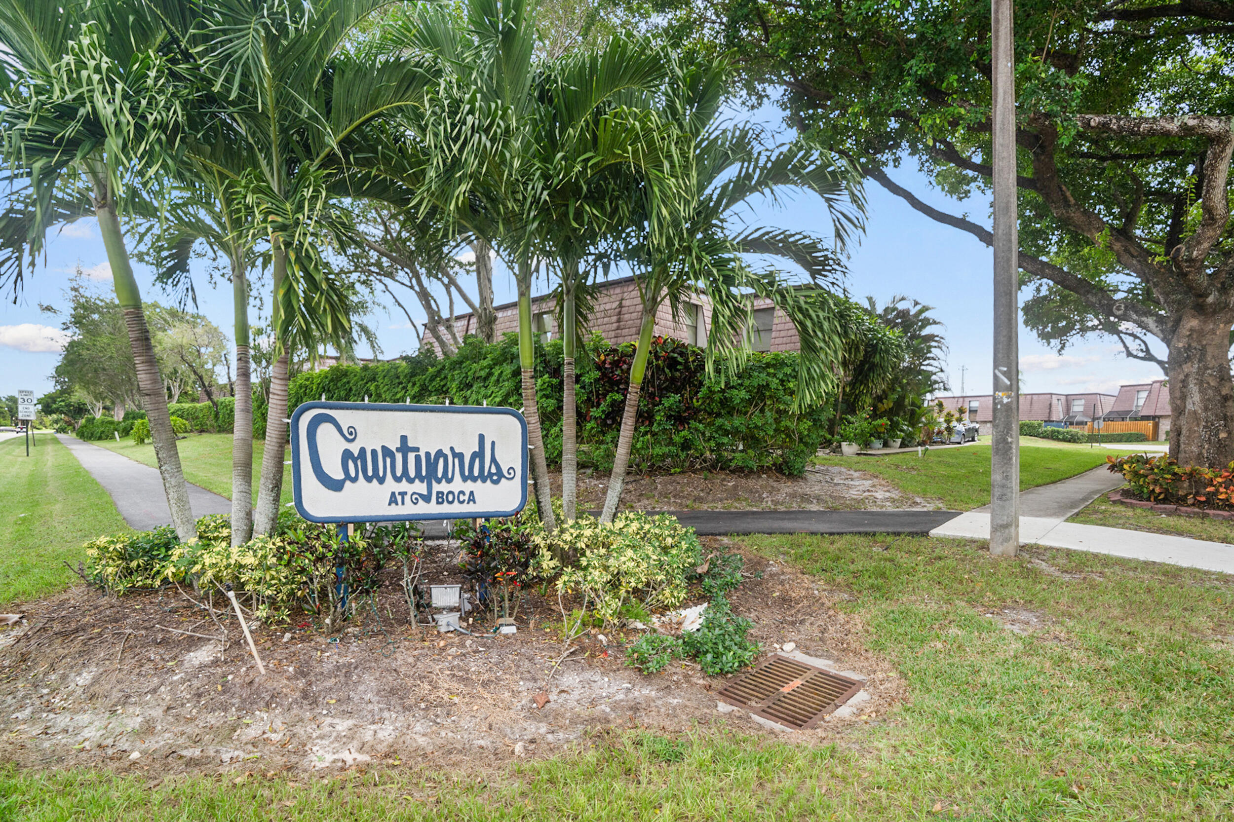 7690 Courtyard Run West Boca Raton, FL 33433 - Photo 21 of 22 a sign that is on the side of a road